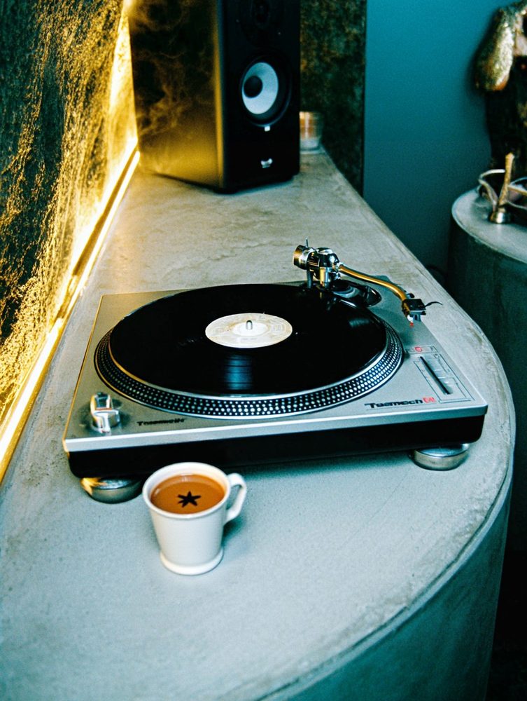 Turntable and espresso on a teal counter
