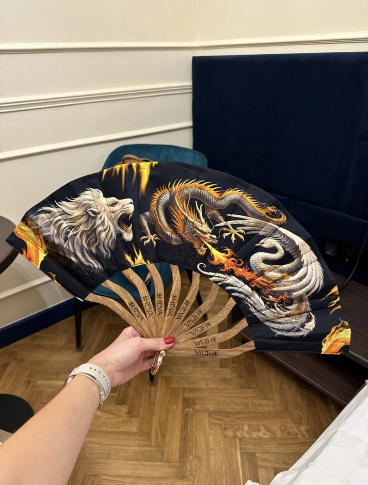 The first fan: lion, dragon and phoenix, held open