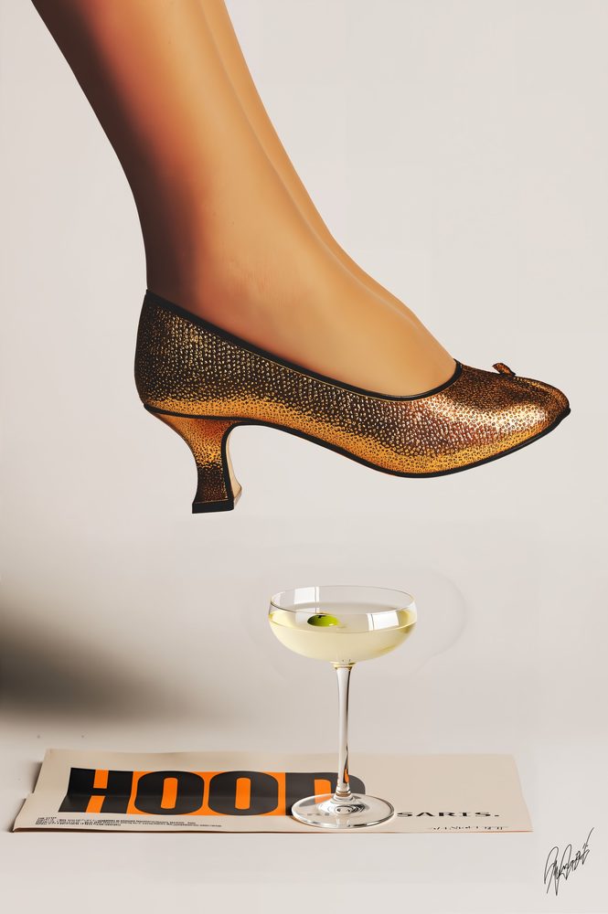 Gold heel stepping over a coupe glass