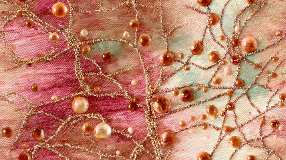 Close detail of a pink and gold pattern with pearls